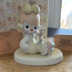 Precious Moments “A Friend Is Someone Who Cares” porcelain figurine.
